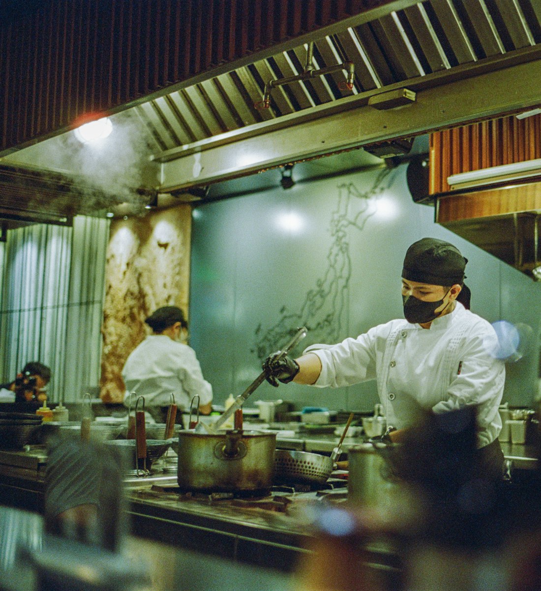 A chef working the pass during a busy dinner service